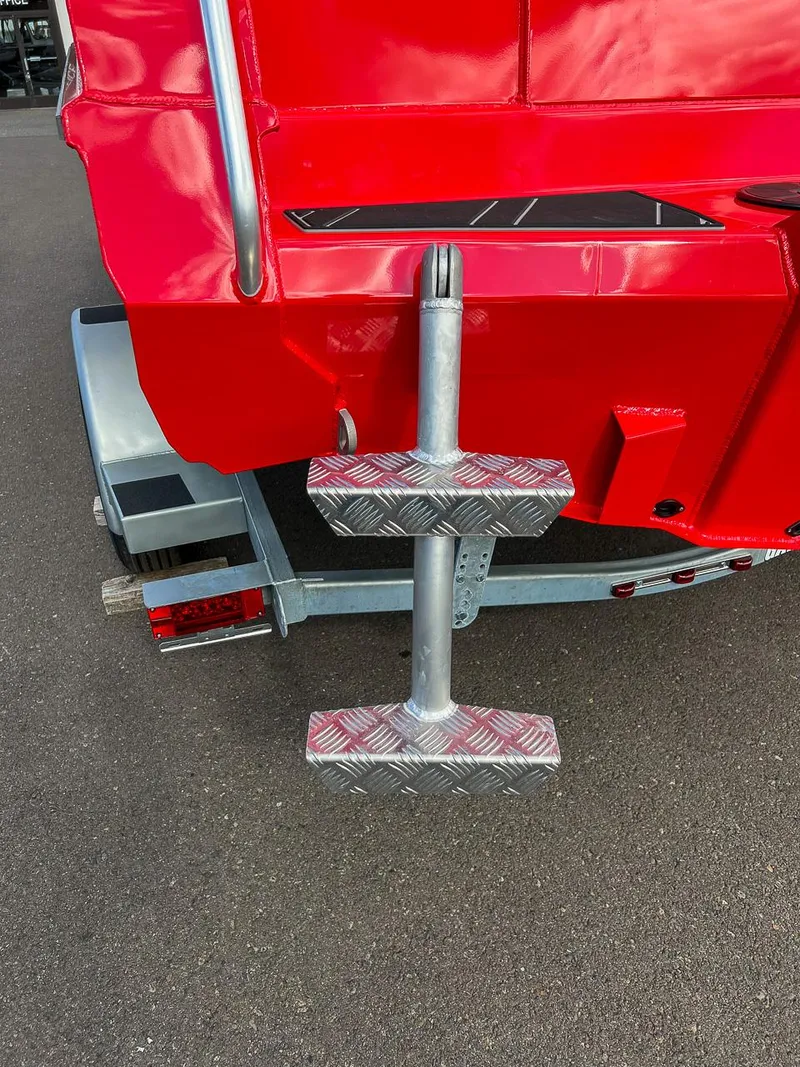 Slide: The Image of Red 2025 Stabicraft 1850 Fisher boat with metal step ladder on trailer. - 21
