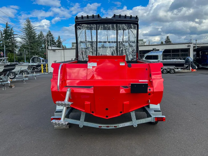 Slide: The Image of 2025 Stabicraft 1850 Fisher in vibrant red, parked outdoors under a cloudy sky. - 4