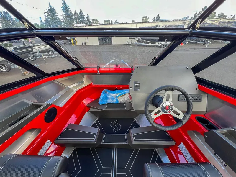 Slide: The Image of 2025 Stabicraft 1850 Fisher boat interior with red accents and modern steering console. - 7