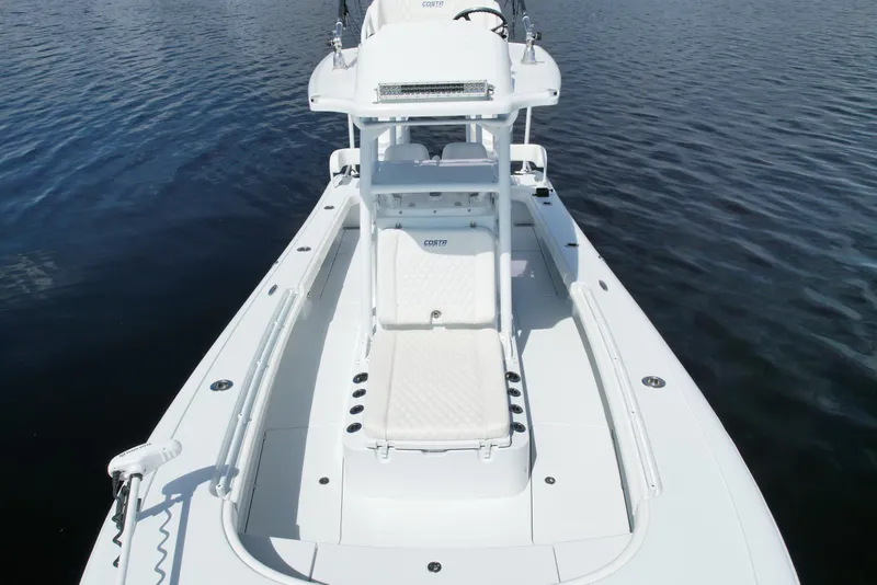 Slide: The Image of 2020 Costa Custom Boats 264 HC on calm water, showcasing sleek design and spacious deck. - 10