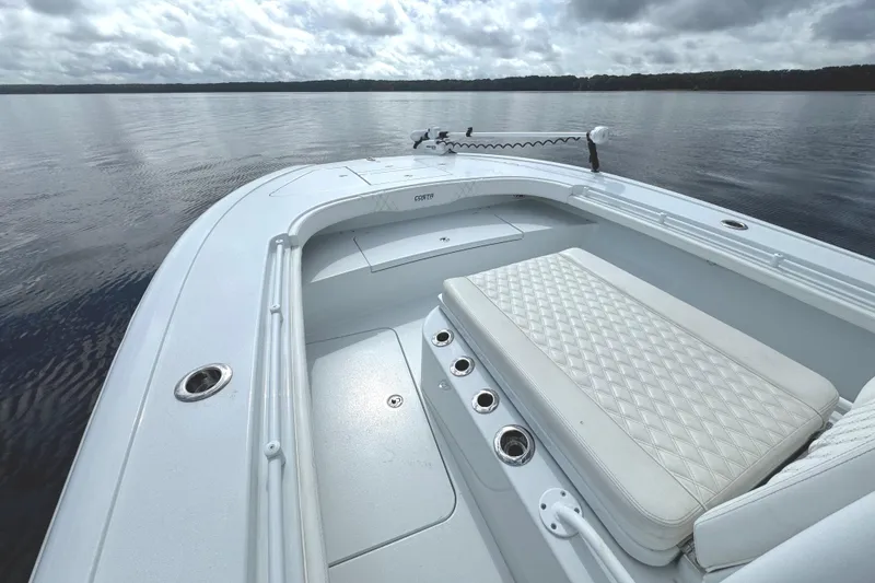 Slide: The Image of 2020 Costa Custom Boats 264 HC on calm water, featuring spacious seating and sleek design. - 13