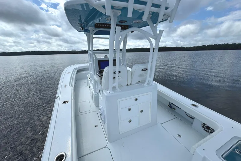 Slide: The Image of 2020 Costa Custom Boats 264 HC on calm water under cloudy sky. - 21