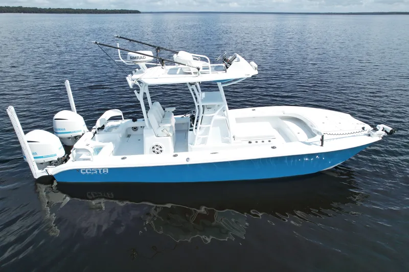 Slide: The Image of 2020 Costa Custom Boats 264 HC on calm water, featuring dual engines and sleek design. - 3