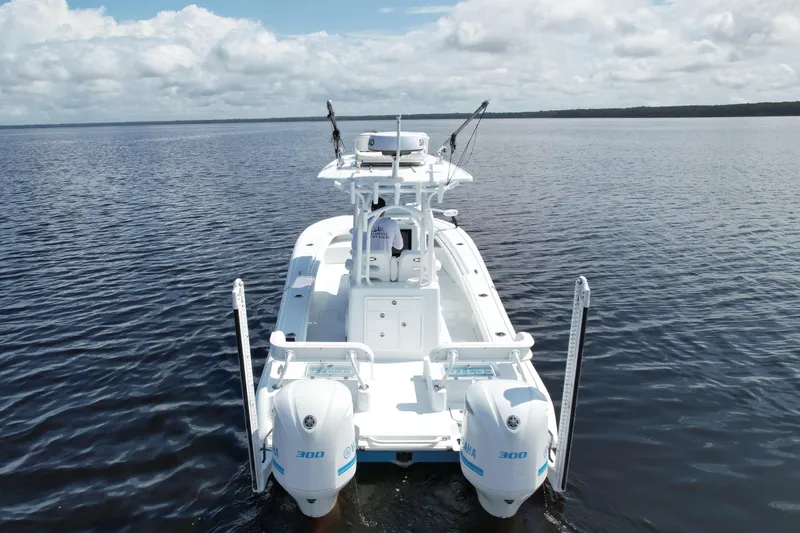 Slide: The Image of 2020 Costa Custom Boats 264 HC on calm water, showcasing dual engines and sleek design. - 9