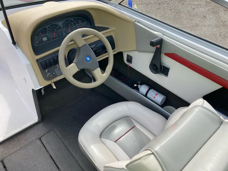 Slide: The Image of 1994 Four Winns 210 Horizon boat interior with steering wheel and dashboard. - 6