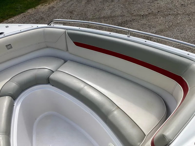 Slide: The Image of 1994 Four Winns 210 Horizon boat interior with white and red cushioned seating. - 9
