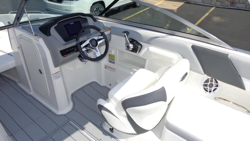 Slide: The Image of 2025 Chaparral 23 SSi boat interior with steering wheel and seating. - 12