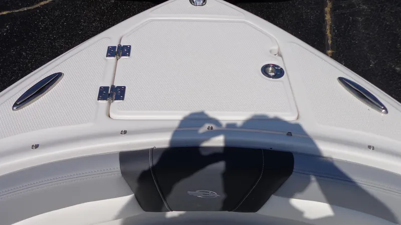 Slide: The Image of 2025 Chaparral 23 SSi boat bow with storage compartment and sleek design. - 25
