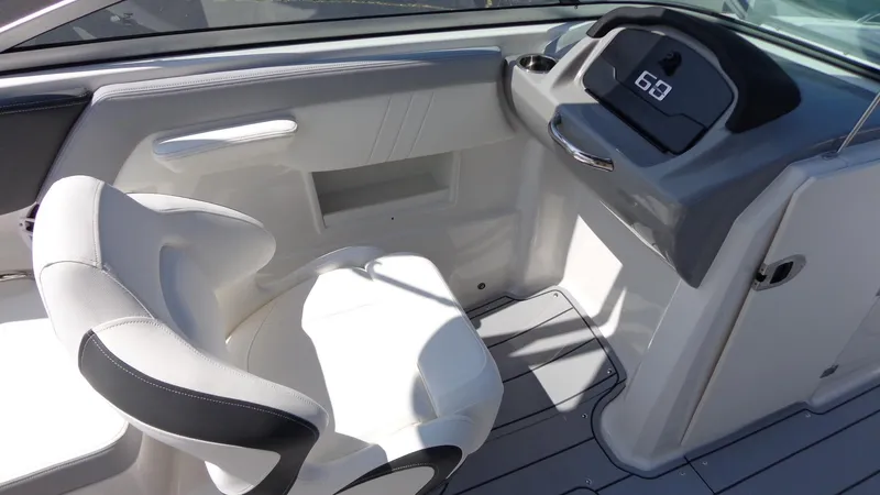 Slide: The Image of 2025 Chaparral 23 SSi boat interior with white seating and modern dashboard. - 29