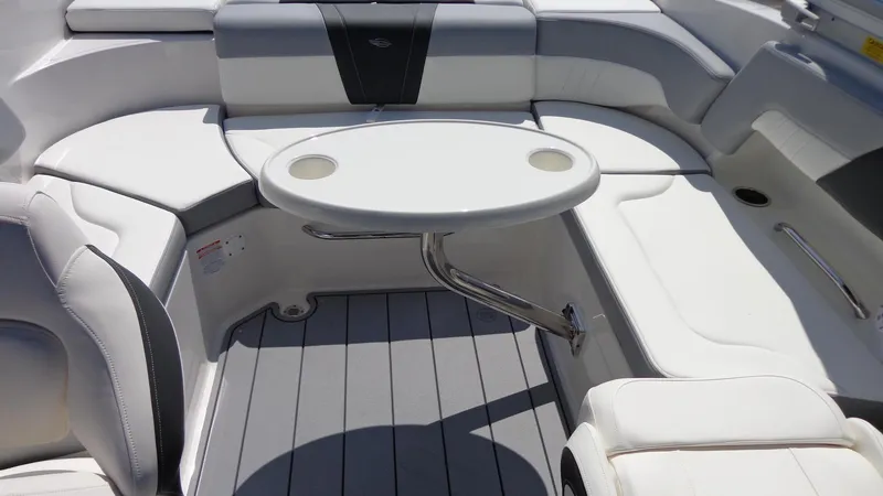 Slide: The Image of 2025 Chaparral 23 SSi boat interior with white seating and round table. - 32