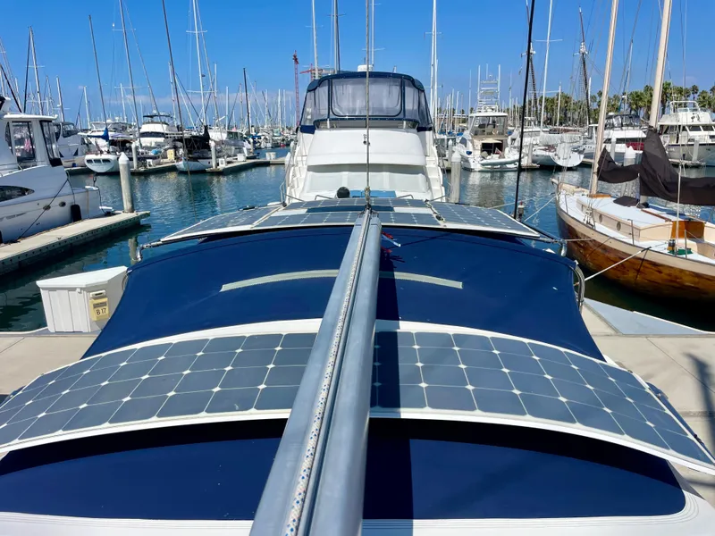 Slide: The Image of Beneteau 423 sailboat with solar panels docked in a marina, 2007 model. - 16