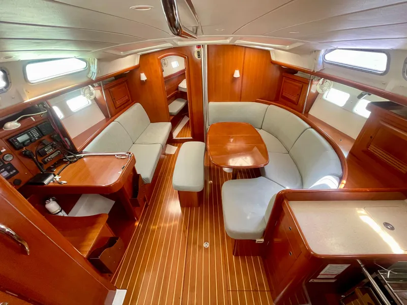 Slide: The Image of Luxurious interior of 2007 Beneteau 423 sailboat with wood finish and spacious seating area. - 23