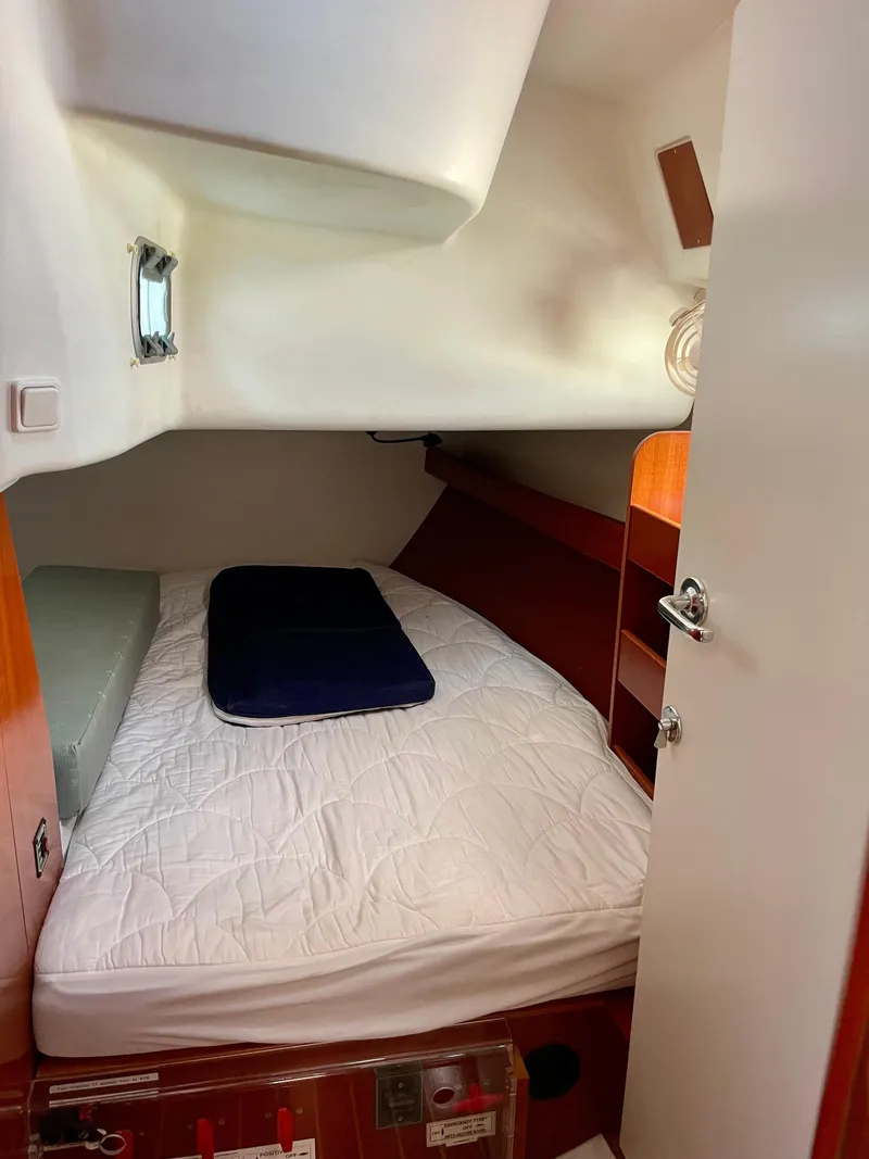 Slide: The Image of Cozy cabin interior of 2007 Beneteau 423 sailboat with bed and storage. - 25