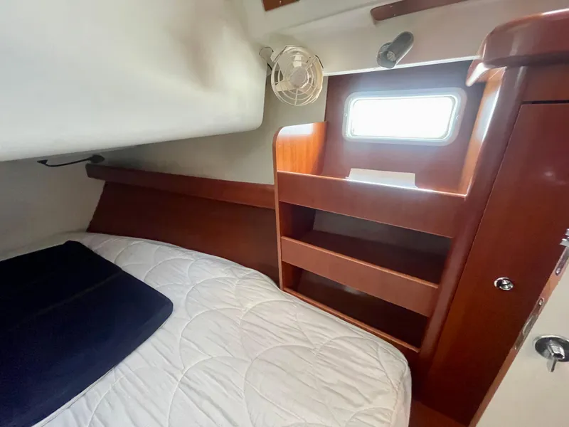 Slide: The Image of Cozy cabin interior of 2007 Beneteau 423 sailboat with bed, shelves, and window. - 28