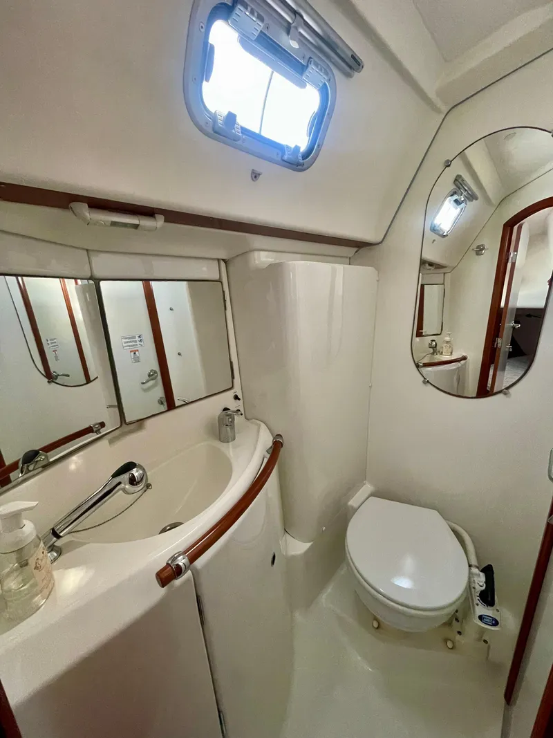 Slide: The Image of 2007 Beneteau 423 yacht bathroom with sink, toilet, and mirror. - 29