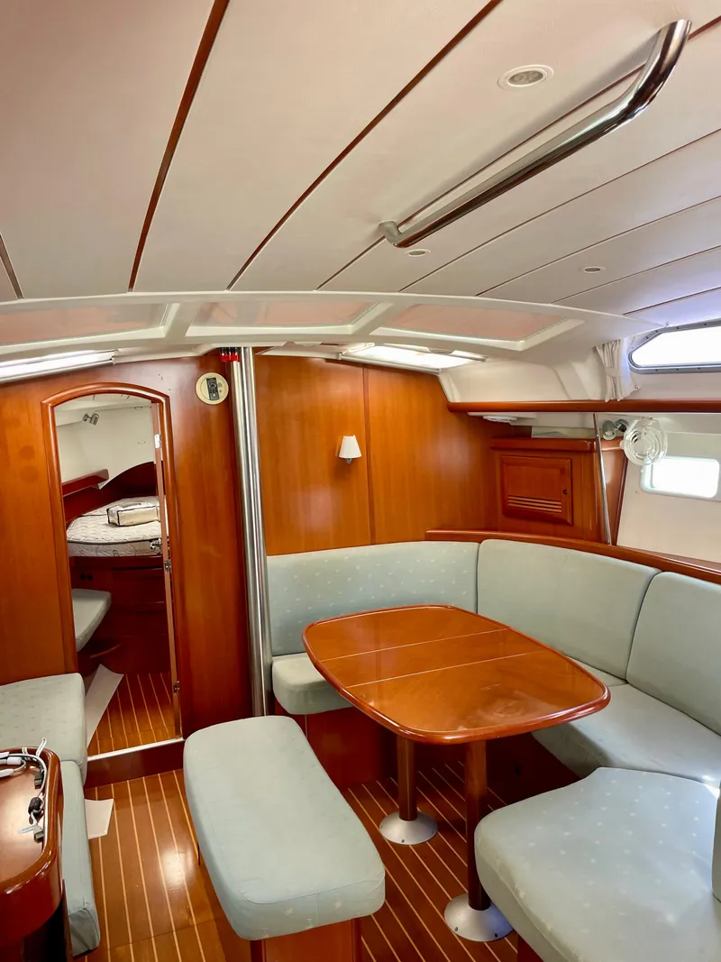 Slide: The Image of Interior of 2007 Beneteau 423 sailboat with wooden finishes and cozy seating area. - 31