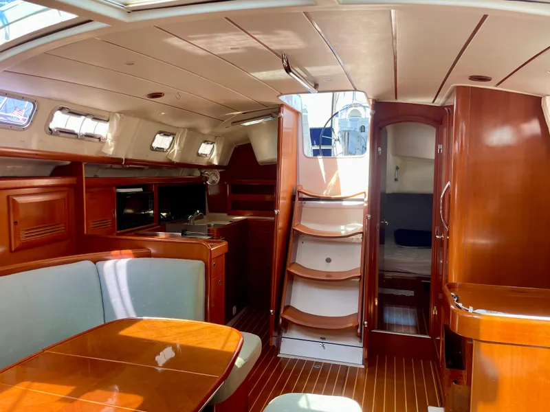 Slide: The Image of Interior of 2007 Beneteau 423 sailboat with wood finish and seating area. - 36