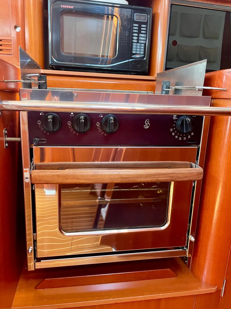 Slide: The Image of Beneteau 423 (2007) yacht kitchen with oven and microwave. - 44