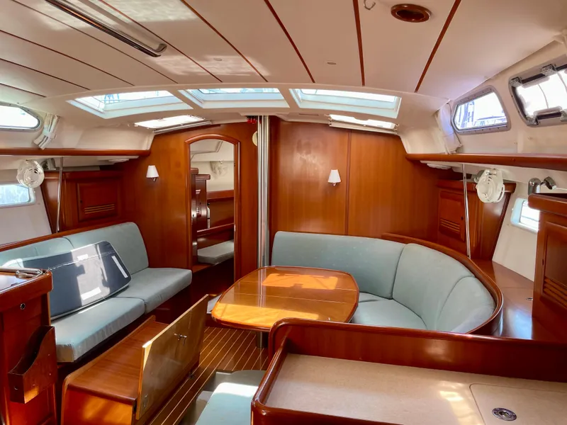 Slide: The Image of Luxurious 2007 Beneteau 423 yacht interior with elegant wood finish and spacious seating area. - 48