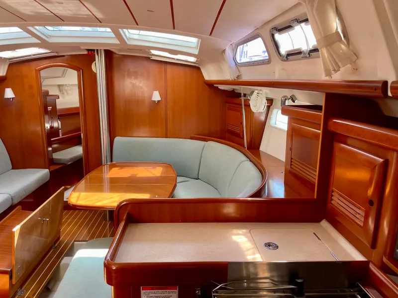 Slide: The Image of Interior of 2007 Beneteau 423 sailboat with wood finish and cozy seating area. - 49