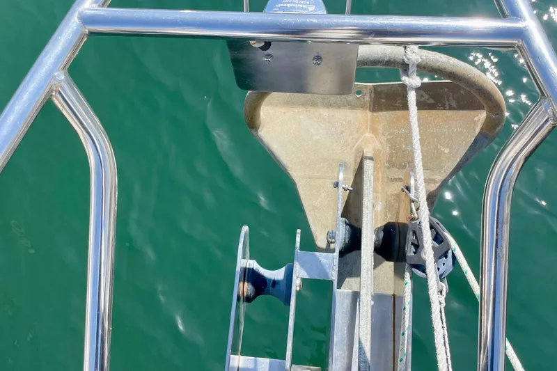 Slide: The Image of Bow of 2007 Beneteau 423 sailboat with anchor and ropes over green water. - 8