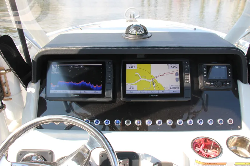 Slide: The Image of 2022 Finseeker 230 CC boat dashboard with navigation and sonar displays. - 11