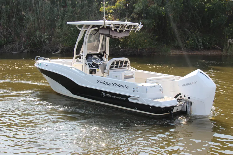 Slide: The Image of 2022 Finseeker 230 CC boat cruising on a calm river. - 14