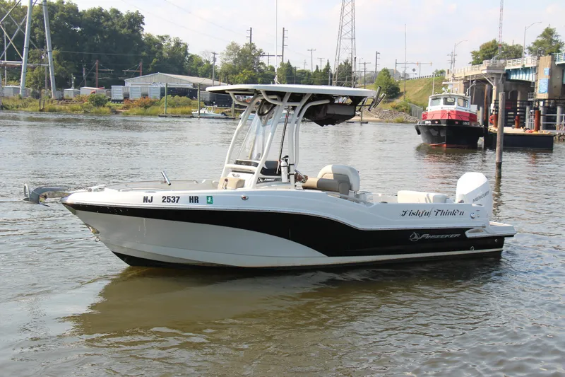 Slide: The Image of 2022 Finseeker 230 CC boat on a calm river. - 16