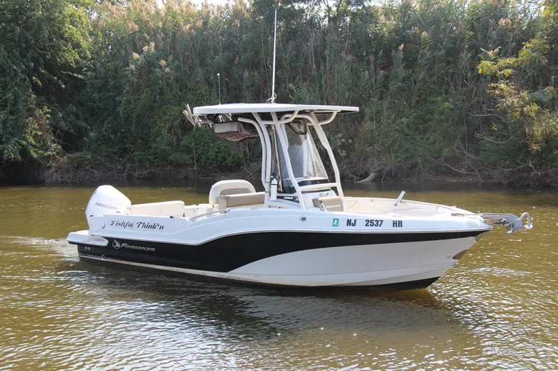 Slide: The Image of 2022 Finseeker 230 CC boat on a calm river, surrounded by lush greenery. - 22