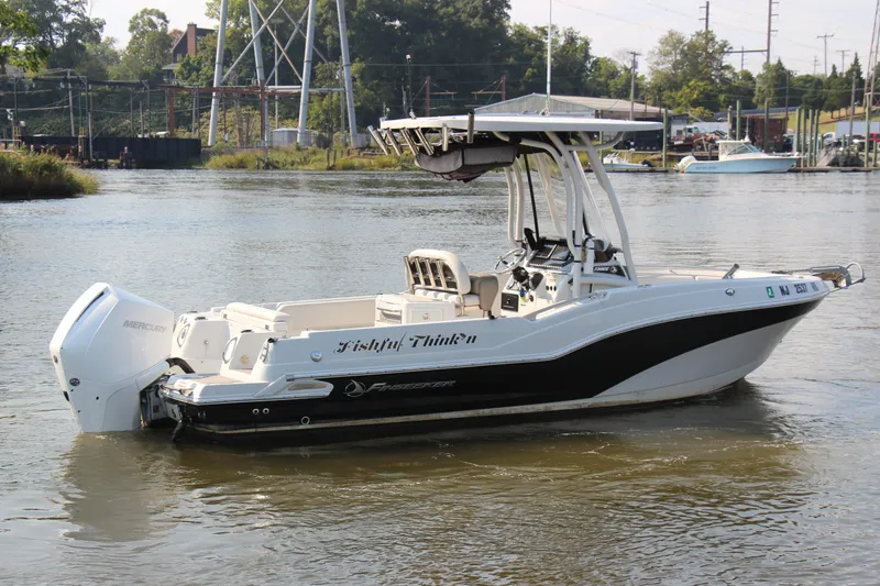 Slide: The Image of 2022 Finseeker 230 CC boat on calm water, featuring sleek design and powerful outboard motor. - 24