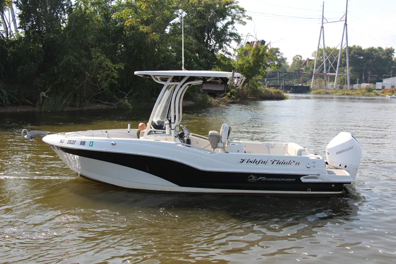 Slide: The Image of 2022 Finseeker 230 CC boat on a calm river, surrounded by lush greenery. - 32