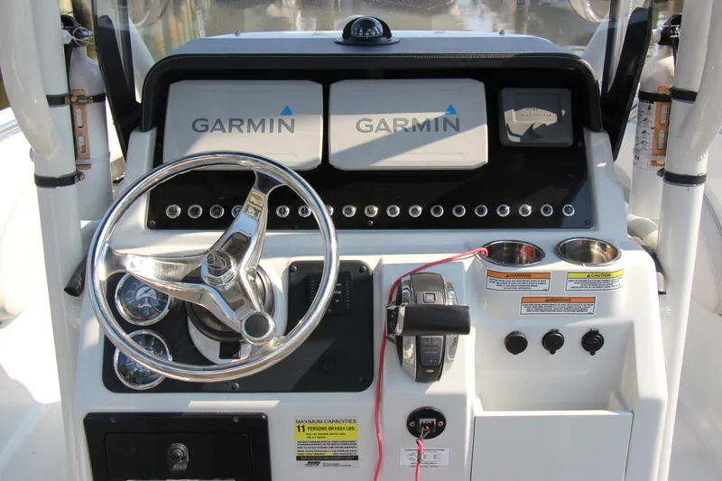Slide: The Image of Finseeker 230 CC 2022 boat dashboard with Garmin displays and steering wheel. - 4