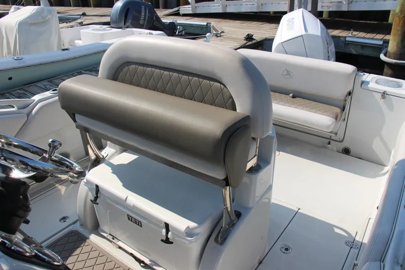 Slide: The Image of 2022 Finseeker 230 CC boat interior with cushioned seating and steering console. - 8