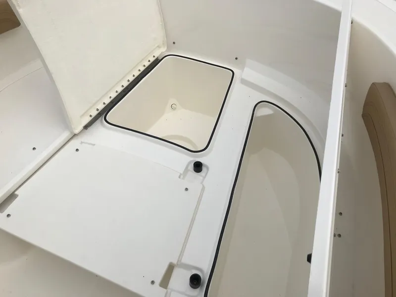 Slide: The Image of 2024 Bayliner Trophy T24CC boat storage compartments and seating area. - 16