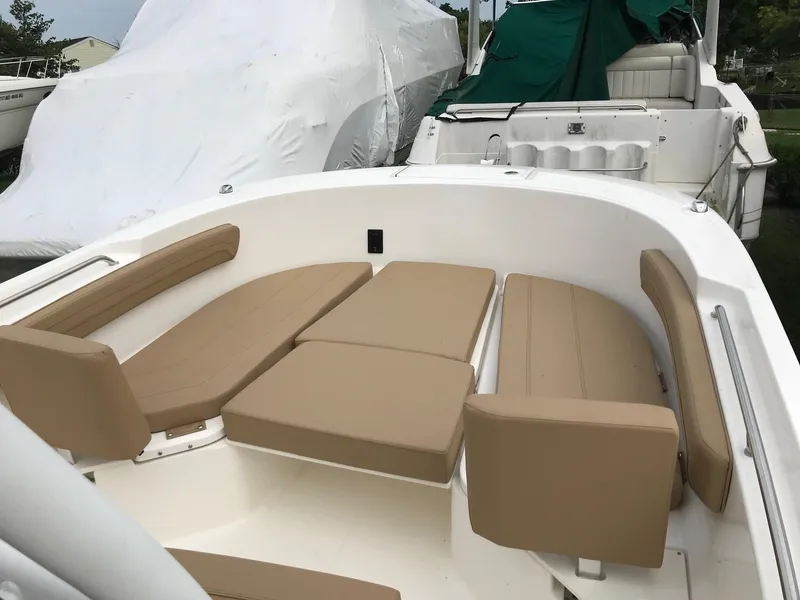 Slide: The Image of 2024 Bayliner Trophy T24CC boat interior with beige cushioned seating. - 7