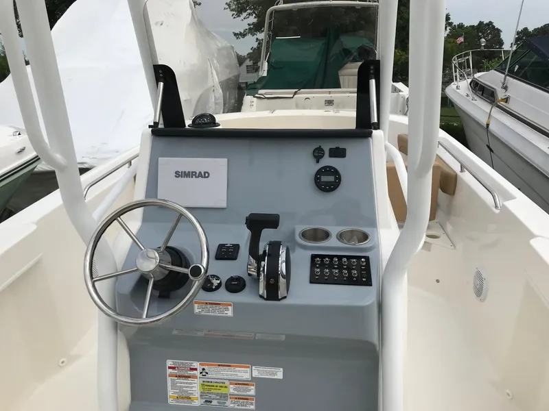 Slide: The Image of 2024 Bayliner Trophy T24CC boat console with steering wheel and controls. - 8