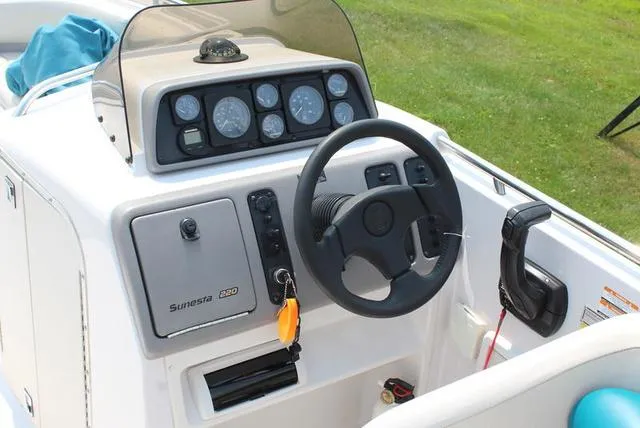 Slide: The Image of 1994 Chaparral 220 Sunesta Deck boat cockpit with steering wheel and instrument panel. - 10