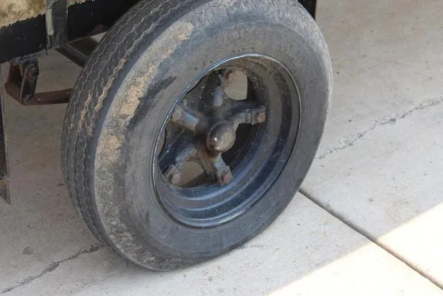 Slide: The Image of Close-up of a worn tire on a 1994 Chaparral 220 Sunesta Deck boat trailer. - 11