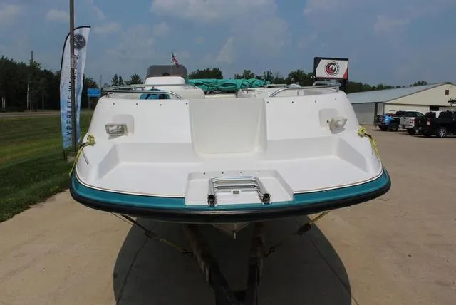 Slide: The Image of 1994 Chaparral 220 Sunesta Deck boat on display outdoors. - 12