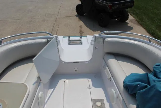 Slide: The Image of 1994 Chaparral 220 Sunesta Deck boat interior with seating and storage compartments. - 13