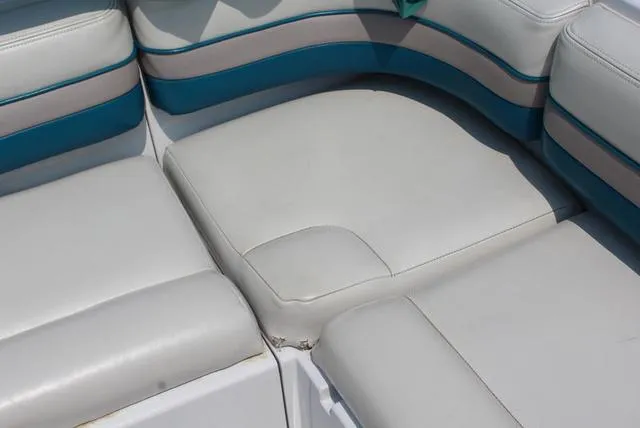 Slide: The Image of Close-up of 1994 Chaparral 220 Sunesta Deck boat seating with white and teal upholstery. - 4