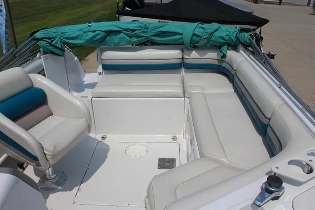 Slide: The Image of 1994 Chaparral 220 Sunesta Deck boat interior with white and teal seating. - 5
