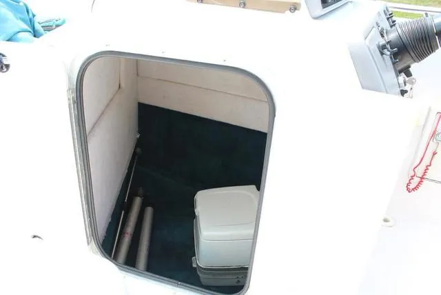 Slide: The Image of 1994 Chaparral 220 Sunesta Deck boat storage compartment with portable toilet. - 6