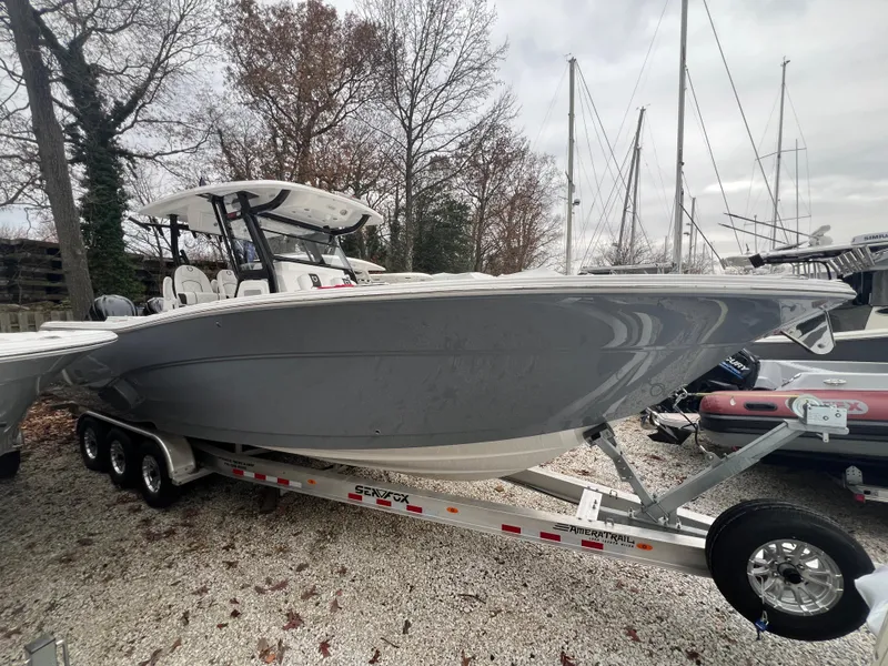 Slide: The Image of 2025 Sea Fox 328 Commander boat on trailer, parked outdoors. - 1