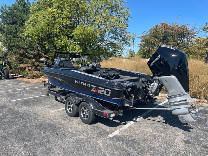 Slide: The Image of 2024 Nitro ZV20 Pro boat with Mercury engine in a parking lot. - 3