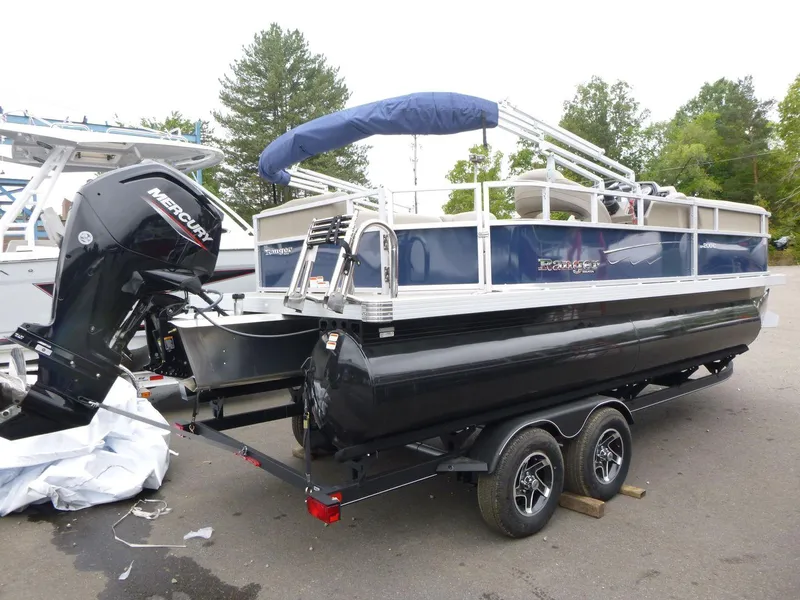 Slide: The Image of 2024 Ranger Reata 200C pontoon boat with Mercury outboard engine on trailer. - 1