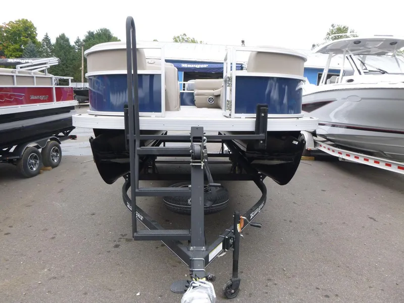Slide: The Image of 2024 Ranger Reata 200C pontoon boat on trailer, parked in marina. - 3