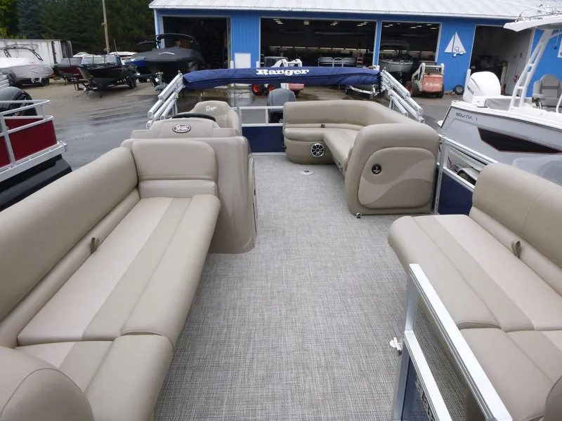 Slide: The Image of 2024 Ranger Reata 200C pontoon boat with spacious seating and modern design. - 4