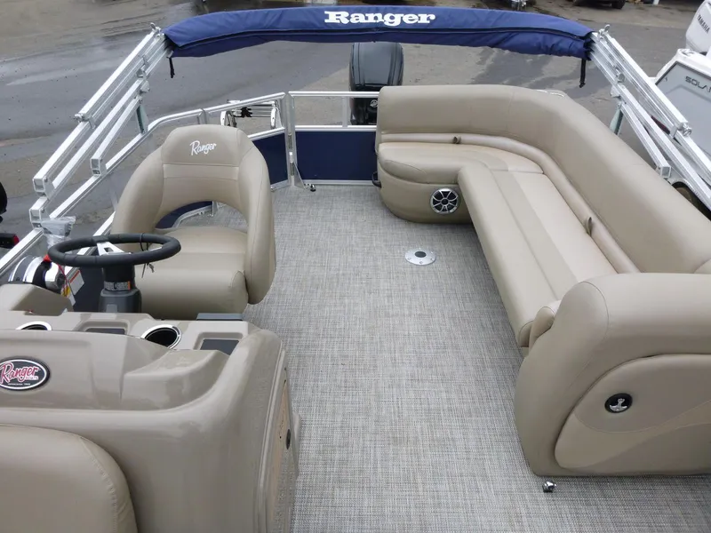 Slide: The Image of 2024 Ranger Reata 200C pontoon boat with beige seating and steering console. - 5