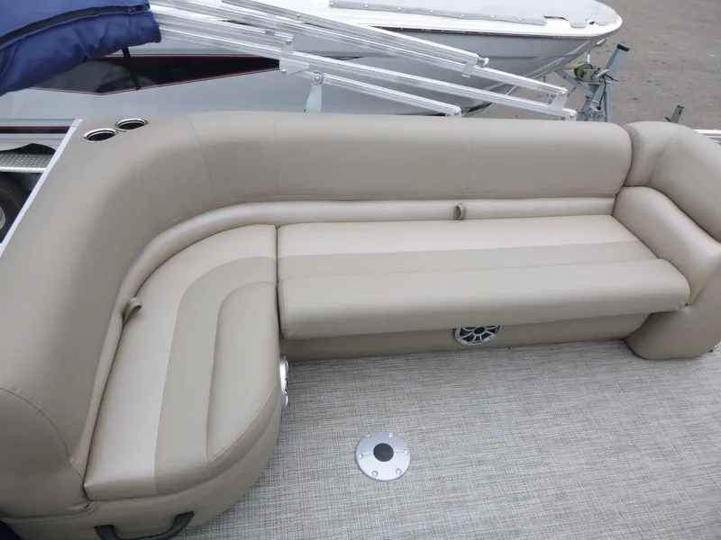 Slide: The Image of 2024 Ranger Reata 200C boat with beige seating and carpeted deck. - 7
